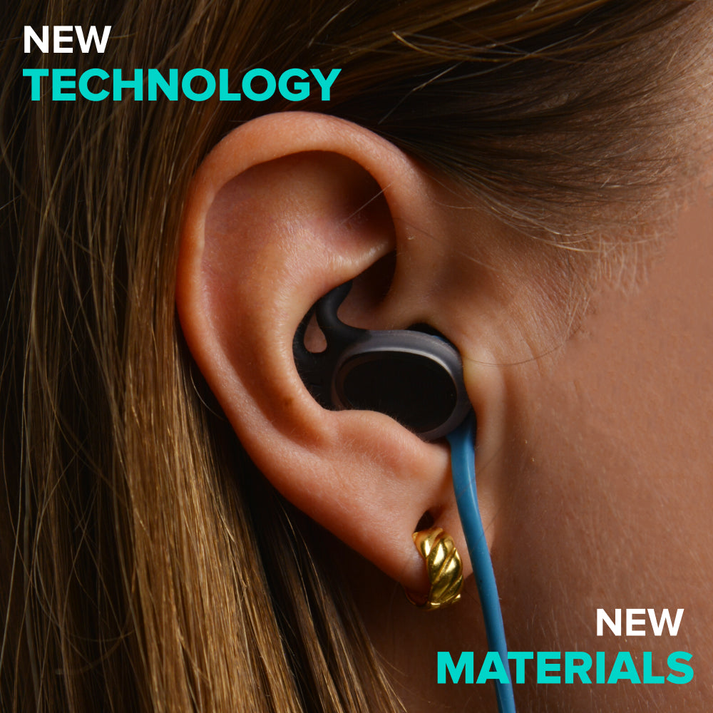 Close-up of an ear wearing a black water-sports earplug highlighting new materials and technology.